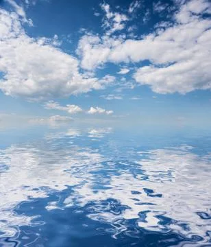 Blue sky reflected in a wate Stock Photos
