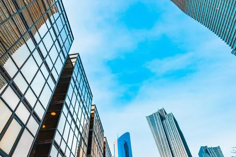 The blue sky is reflected in the windows of a modern office building Stock Photos