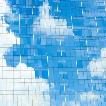 Blue sky reflection on office building Stock Photos