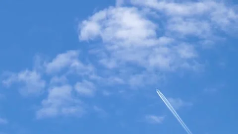 Blue Sky with Scattered Cumulus Clouds and a Tiny Speck Stock Footage 302298499