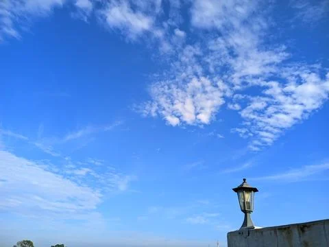 Blue Sky with Scattered White Clouds and Vintage Street Lamp Stock Photos