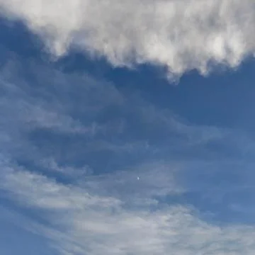Blue sky with scattered white clouds Stock Photos