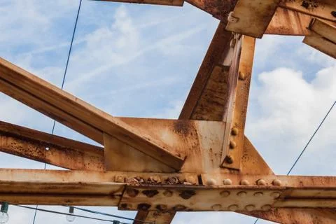 Blue sky seen through open rusted girders urban landscape Stock Photos