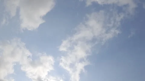 Blue sky showing fluffy white clouds. Clear weather backdrop, light atmosphere, Stock Footage 343161010