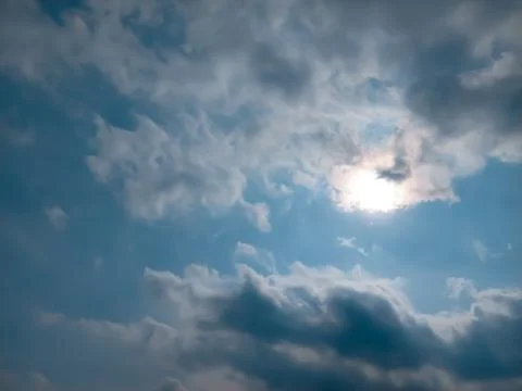 Blue sky showing through a cloudy sky and sun Dhaka, Bangladesh Stock Photos