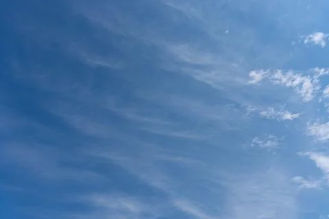 The blue sky with a slight layer of clouds on it Stock Photos