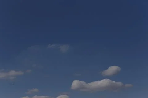 Blue sky with small cloud shapes Stock Photos