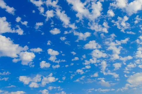 Blue sky with small white clouds. Natural background Stock Photos