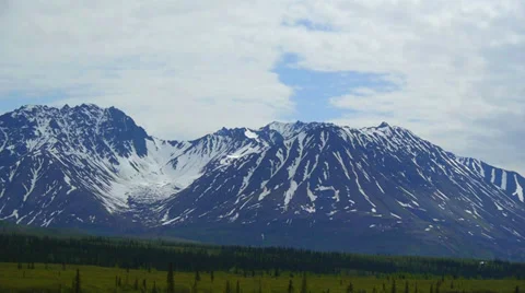 Blue Sky, Snow Capped Mountains, and Green Trees Stock Footage 37403848