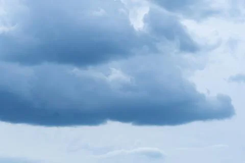Blue sky with soft Cumulus dark blue clouds Stock Photos