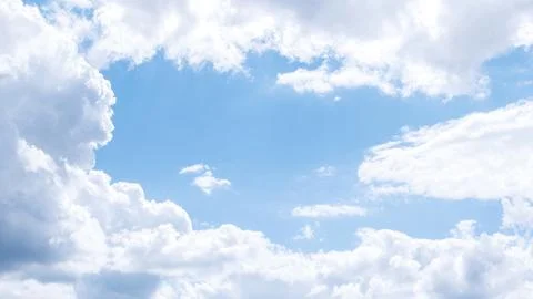 Blue sky with soft fluffy clouds, cloud frame with space for text Stock Photos
