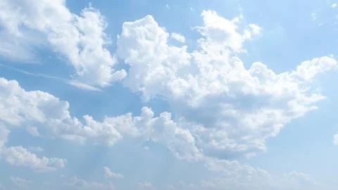 Blue sky with soft fluffy clouds Stock Photos