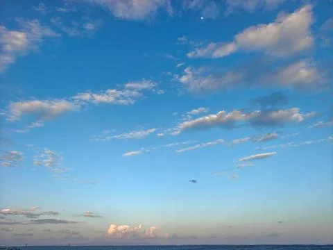 Blue Sky with Soft Fluffy Clouds and Horizon Over Ocean Stock Photos