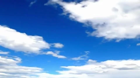 Blue sky with soft fluffy white clouds slowly moving, seamless loop. Stock Footage 316766569