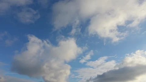 Blue sky with soft white clouds drifting in peaceful daylight Stock Footage 327840184