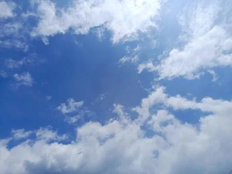 Blue Sky with Soft White Clouds on Clear Day Stock Photos