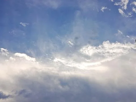 Blue Sky with Soft White Clouds and Sunlight Natural Cloudscape Background Stock Photos