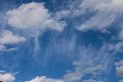 Blue sky with soft white clouds and wispy cirrus patterns creating abstract.. Fotos Stock