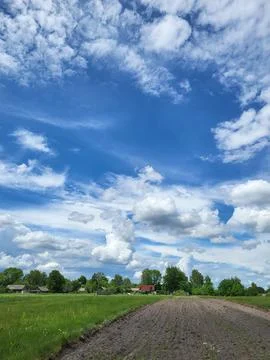 Blue sky with soft white clouds over horizon Stock Photos