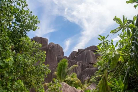 Blue sky with some clouds and big stones in front Stock Photos