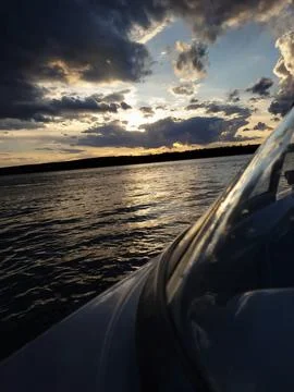 Blue sky with some clouds with sunset lights in the background Stock Photos