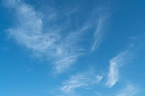 Blue sky with some wispy clouds Stock Photos