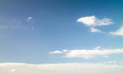 Blue sky with sparse clouds faced in front Foto stock
