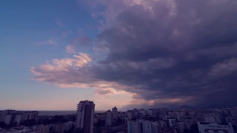 Blue sky a storm formation with gray clouds, orange and teal effect Stock Footage 106445744