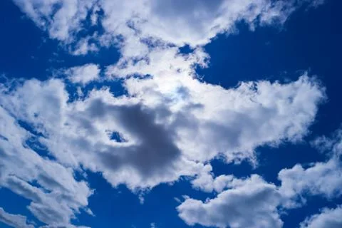 Blue sky with sun and clouds Stock Photos