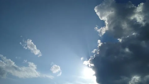 In a blue sky, the sun comes out from behind a cloud Stock Footage 161915580