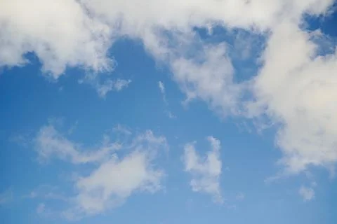 Blue sky surrounded by soft white clouds Фото