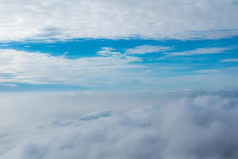 The blue sky with thick clouds floats and looks beautiful. Stock Photos