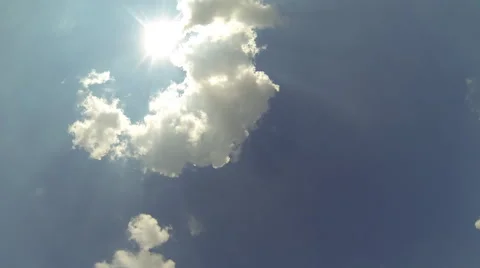 Blue sky timelapse with sun going behind small clouds Stock Footage