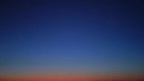 Blue sky at twilight transitioning into evening darkness, time lapse. Gradien Stock Photos
