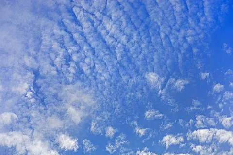 A blue sky with undulating clouds Stock Photos