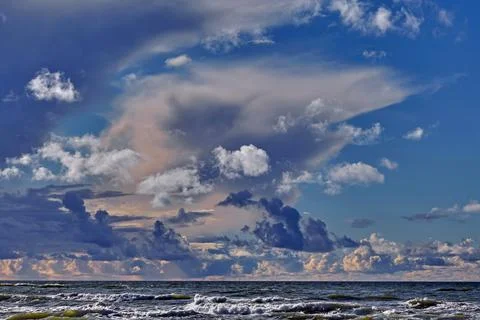 Blue sky with various clouds and stormy sea. Seascape on the Baltic Sea Stock Photos