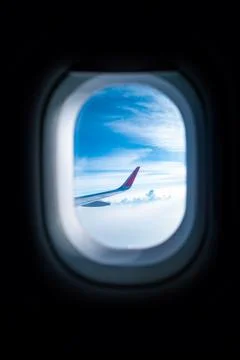 Blue sky view from airplane window with dark copy space for text Stock Photos