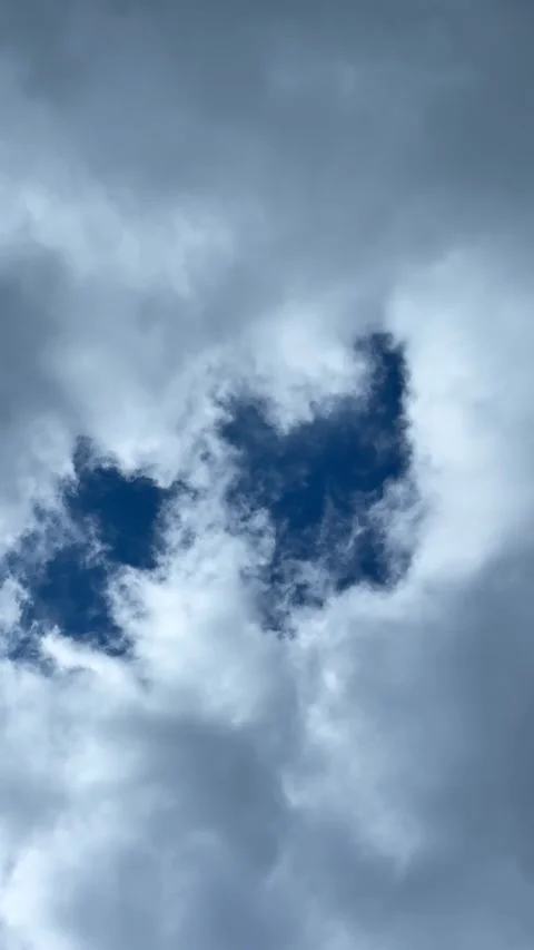 Blue sky view through dramatic fluffy clouds on sunny day Stock Footage 311982140