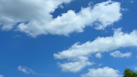 Blue sky view through dramatic fluffy clouds on sunny day Stock Footage 311982242