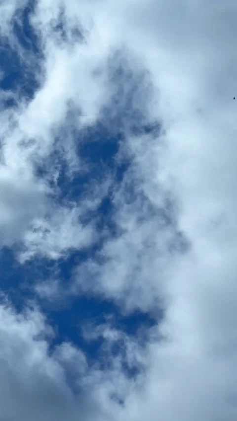 Blue sky view through dramatic fluffy clouds on sunny day Stock Footage 311982247