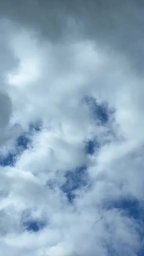 Blue sky view through dramatic fluffy clouds on sunny day Stock Footage 311982265
