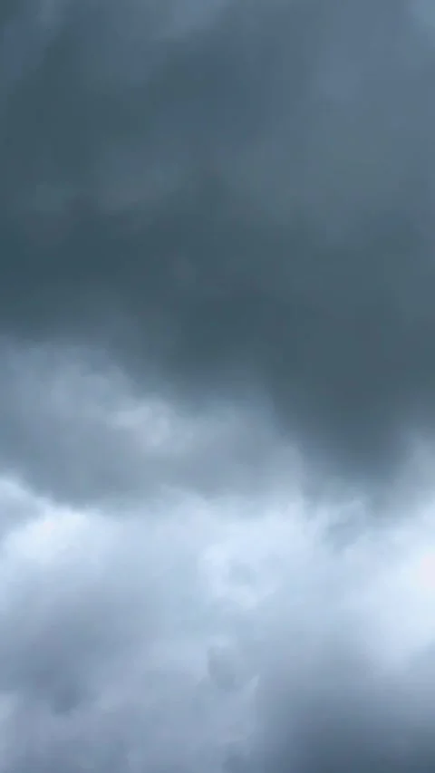 Blue sky view through dramatic fluffy clouds on sunny day Stock Footage 311982382