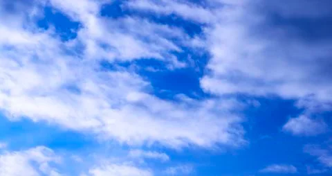 A blue sky is visible through the clouds in the early morning at sunrise. Stock Photos