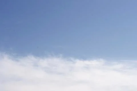 Blue sky with a white cloud. abstract glowing background Stock Photos