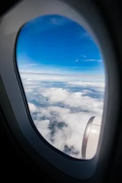 Blue sky white cloud ,looking through airplane window frame Stock-Fotos