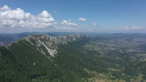 Blue sky with white clouds above Veliki Krs mountain ranges 4K aerial video Stock Footage 120825946