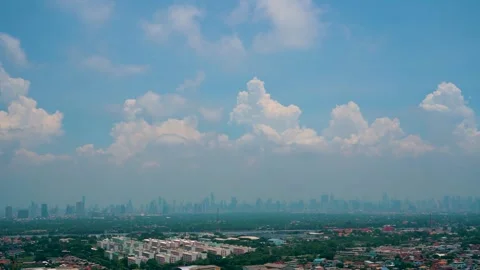 Blue sky white clouds above the city urban skyscrapers by the river. Puffy Stock Footage 277682870
