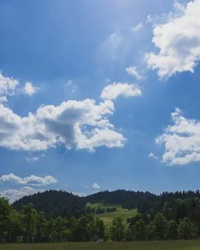 Blue Sky with White Clouds Above Rolling Green Hills Photos