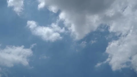 A blue sky with white clouds is adorned with a brilliant shade of blue, ado.. Stock Footage 277171662