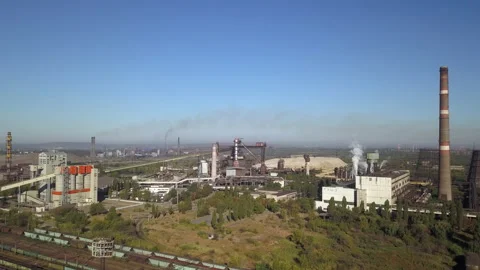 Blue sky with white clouds against the background of a metallorgic plant smoking Stock Footage 196396510